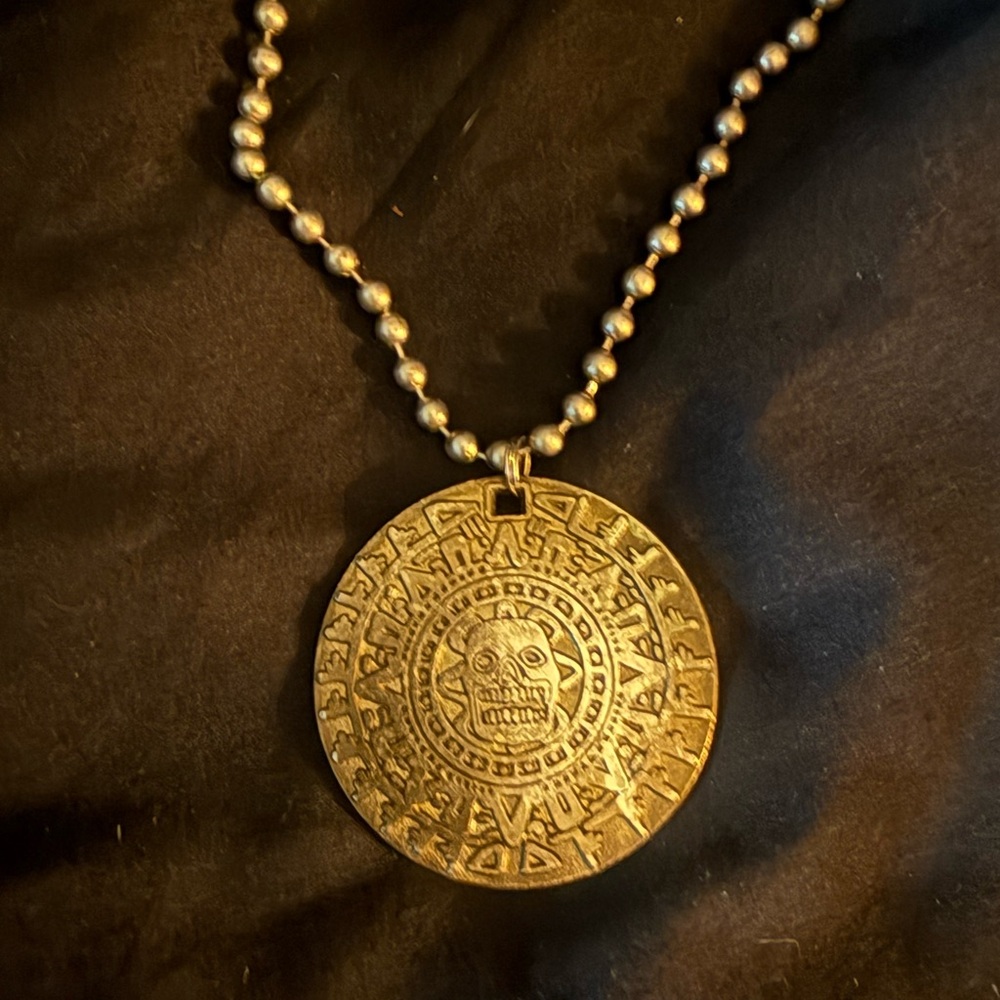 Brass pendant engraved with Mayan art